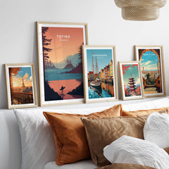 Tofino Canada Travel Poster | Sunset Beach Landscape Wall Art Print displayed among other travel posters in a cozy interior setting.