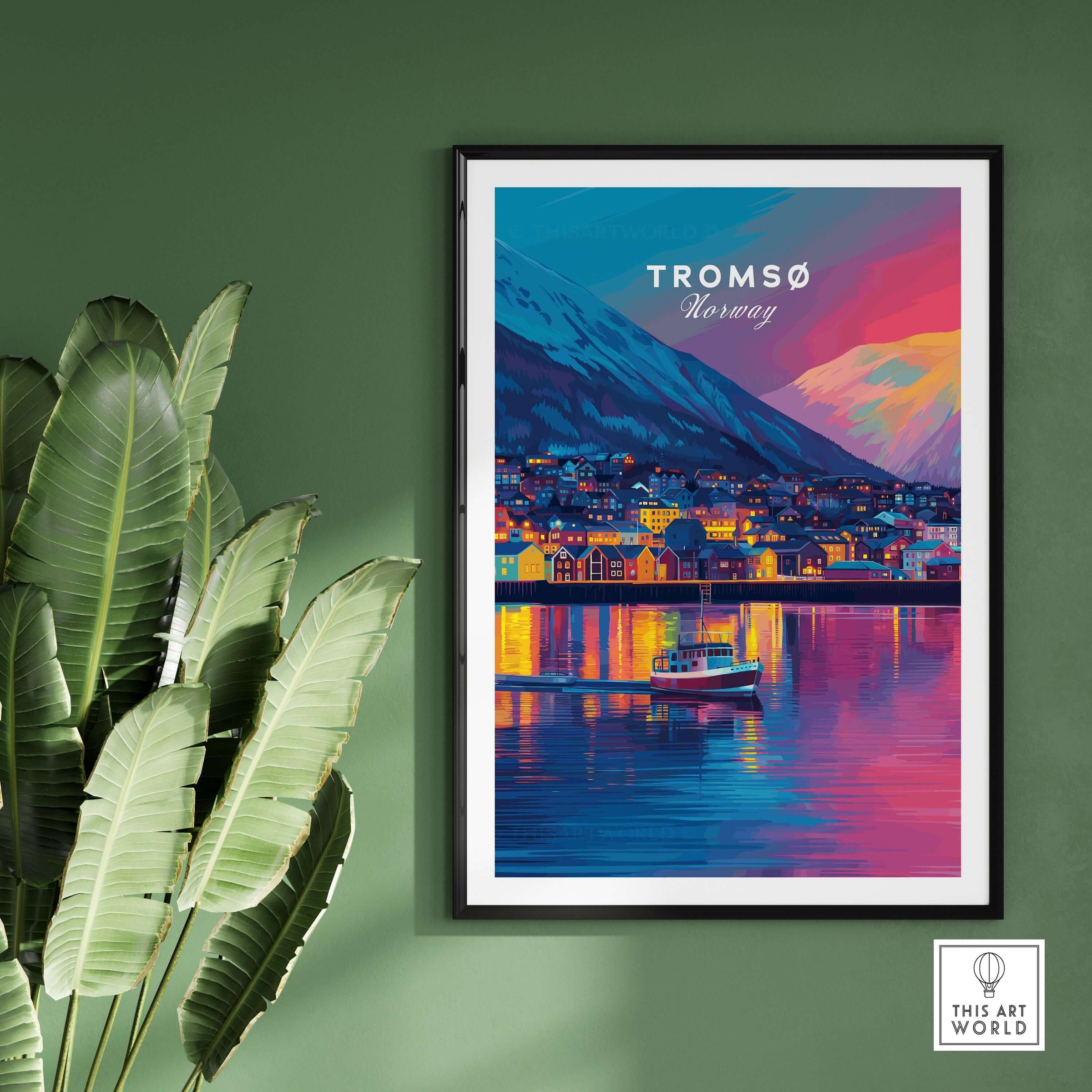 Tromsø Arctic City Lights and Aurora Sky Print | Nordic Travel Art framed on a green wall with plants.