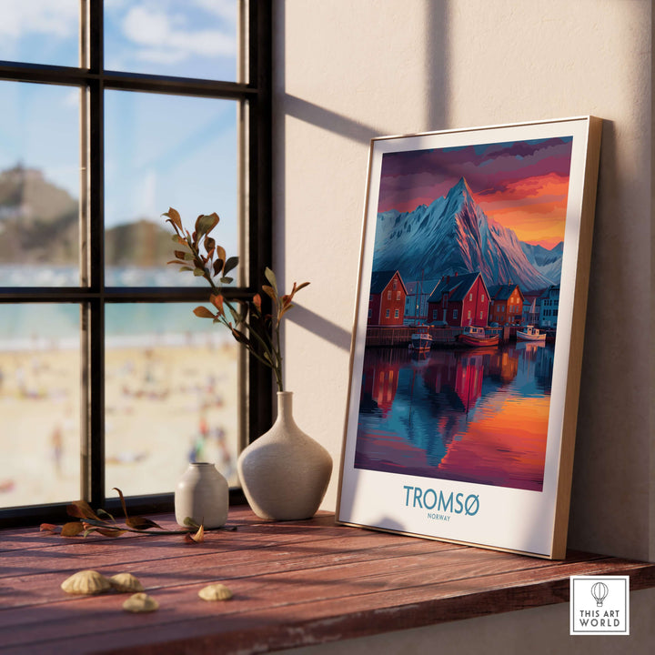 Tromsø Norway Art Print framed on a wooden table near a window, showcasing scenic Arctic beauty and coastal charm.