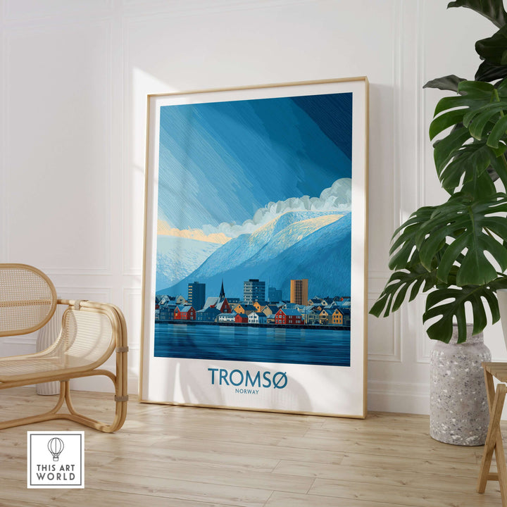 Tromsø Norway Art Print | Snowy Mountain City Poster displayed in a bright room with plants and seating.
