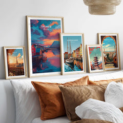 Tromsø Norway Fjord Town Sunset Print | Nordic Travel Wall Decor displayed among other travel art prints on a stylish couch.