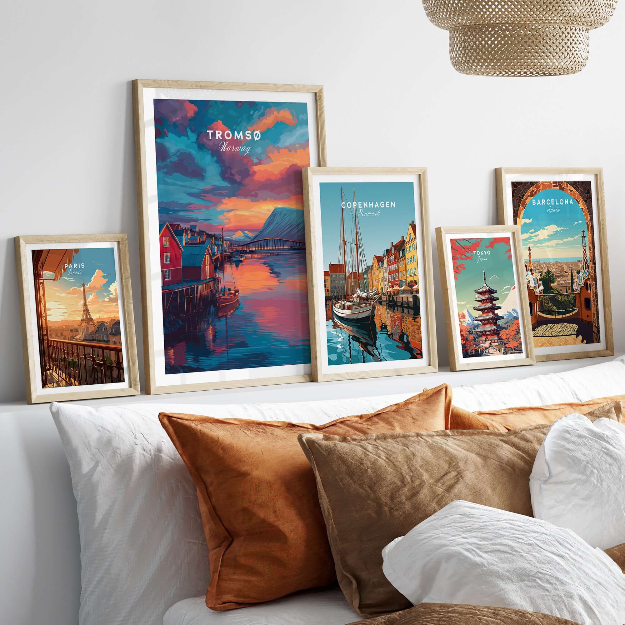 Tromsø Norway Fjord Town Sunset Print | Nordic Travel Wall Decor displayed among other travel art prints on a stylish couch.