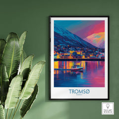 Tromsø Norway Winter Night Art Print | Colorful City Poster framed on a wall with a plant in the foreground.
