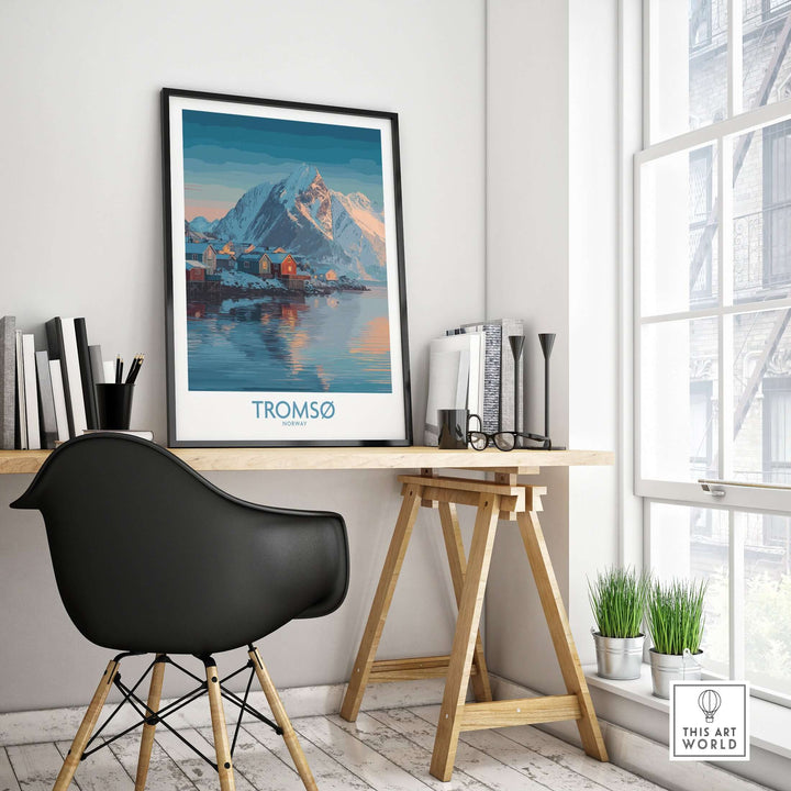 Tromsø Norway Art Print | Winter Village Poster displayed in a modern workspace with mountain backdrop.