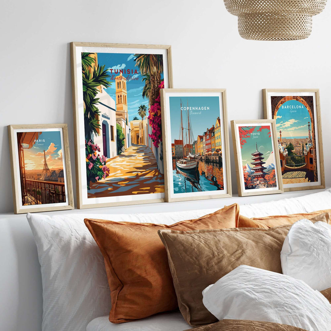Gallery of framed travel art prints, featuring Tunisia, Copenhagen, and Barcelona, on a stylish living room wall.