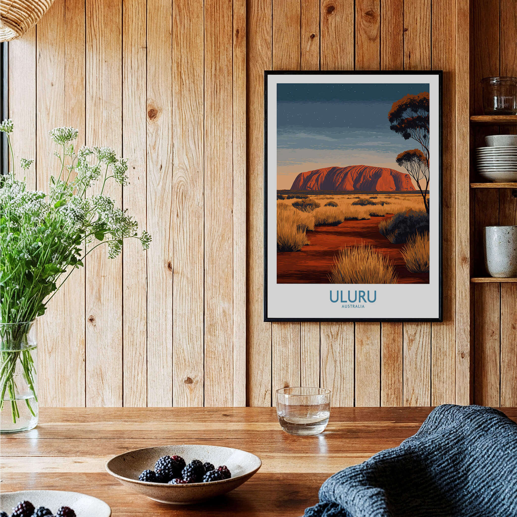 Uluru Australia Poster | Desert Sunset Canvas Print displayed on a wooden wall with plants and decorative items.
