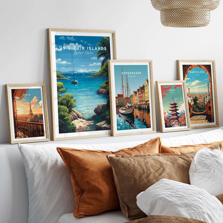 Framed travel posters including US Virgin Islands and other cities, displayed on a stylish wall above a cozy bed.