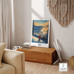 Vail ski poster print on wooden bench in cozy living room, showcasing a scenic Colorado mountain landscape.