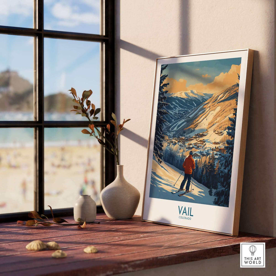 Vail Colorado ski poster print displayed on a windowsill with mountains in the background, capturing a picturesque winter scene.