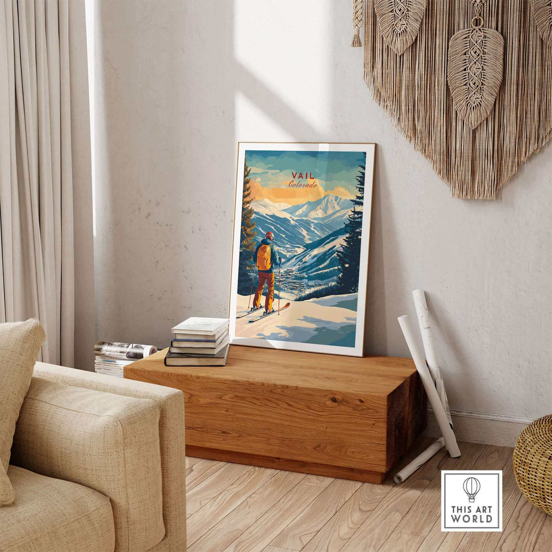 Vail Ski Poster in wooden frame on bench, Colorado mountain scene, modern interior decor with books and textured wall hanging.