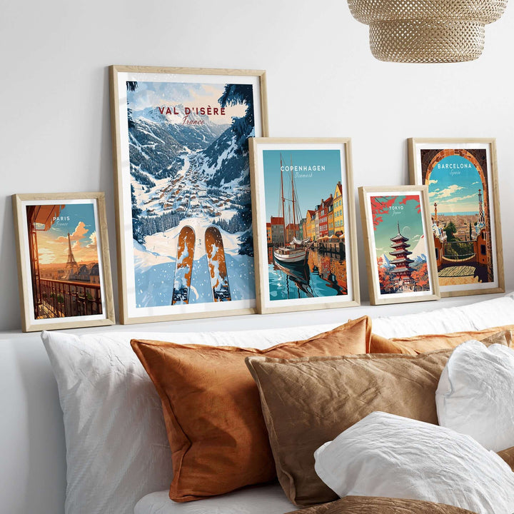 Framed Val d'Isere ski print among travel-themed posters on a stylish sofa, showcasing beautiful home decor.