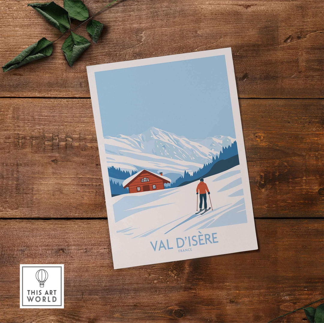 Val-d'Isère print showcasing a skier on snowy slopes with mountains and a cabin, by This Art World, on a wooden surface.