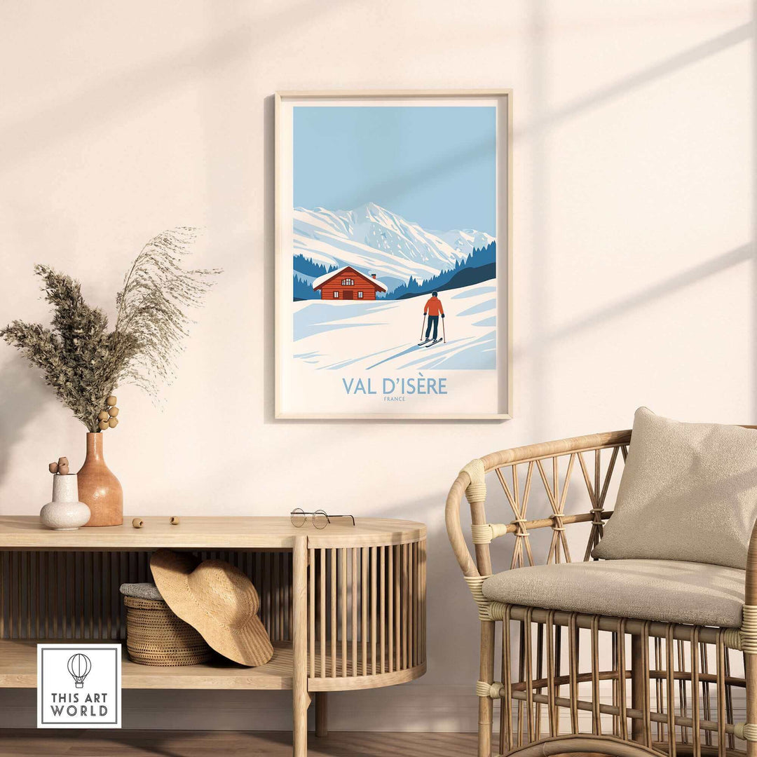 Val-d'Isère print featuring a skier on snowy slopes, displayed in a stylish room setting with neutral decor and wicker chair