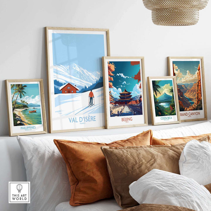 A collection of framed travel prints on a wall, featuring destinations like Val-d'Isère, Beijing, and more, in a cozy home setting.