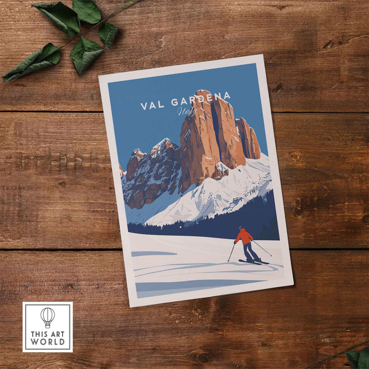 Val Gardena ski poster featuring a skier in Italy, with snowy mountain landscape, displayed on a wooden table.