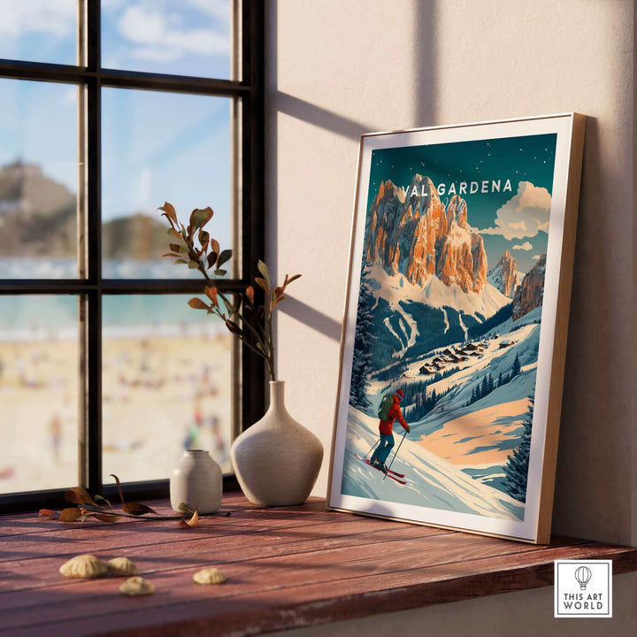 Val Gardena Ski Poster displayed by a sunlit window, showcasing Italy's snowy mountains and a skier, by This Art World.