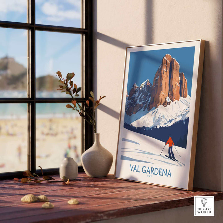 Val Gardena wall art ski poster displayed on a sunny windowsill with a scenic alpine landscape and skier in the artwork.