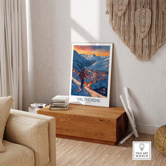Val Thorens ski print decor in a cozy living room, showcasing snowy mountains and sunset, perfect for ski enthusiasts.