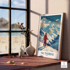Val Thorens Skiing Poster displayed on a windowsill, showcasing stunning mountain landscapes and ski adventure vibes.