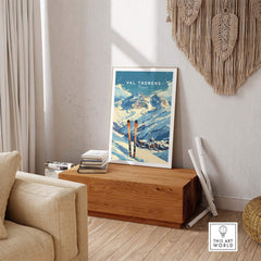 Val Thorens travel poster displayed in a cozy living room, highlighting snowy slopes and ski gear. Perfect for ski enthusiasts.