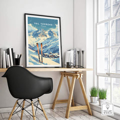 Val Thorens travel poster displayed in a stylish home office with skis, showcasing picturesque alpine views.