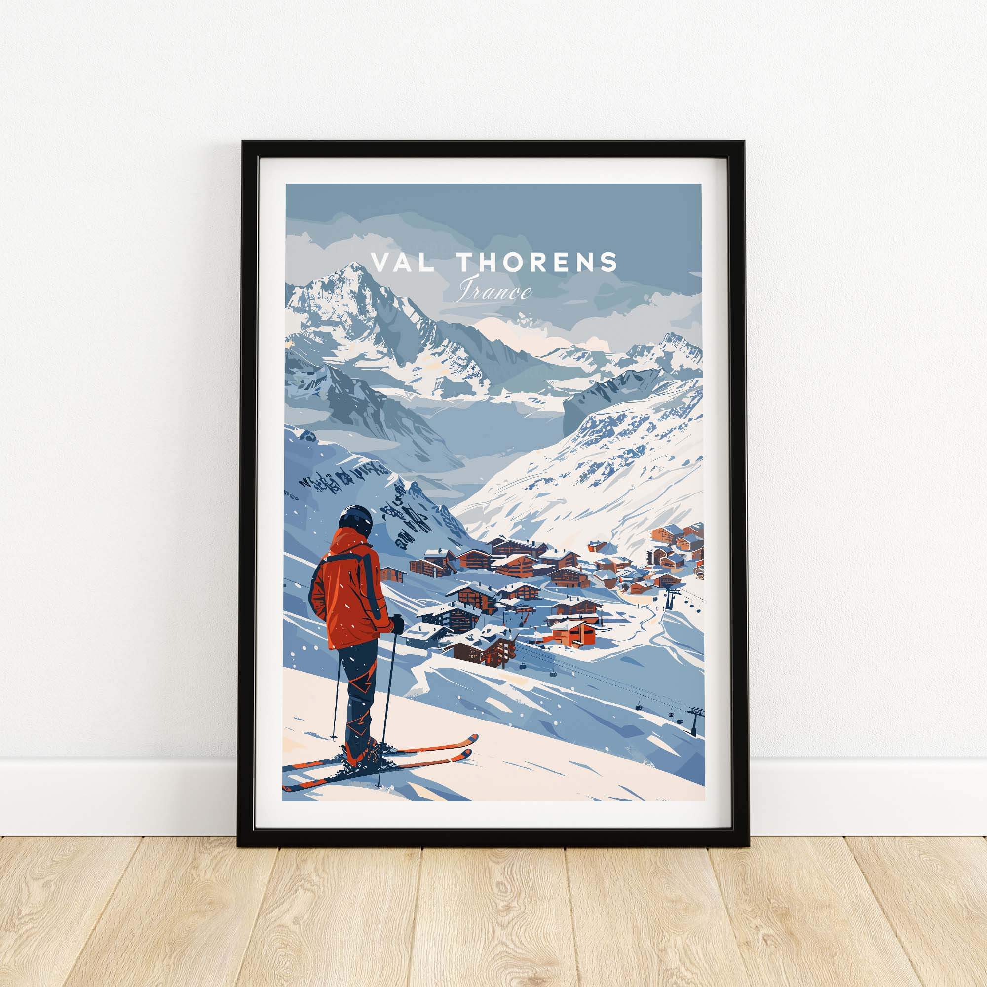 Val Thorens Wall Art Print featuring a skier in red overlooking the snowy village and mountains in France. Perfect for home decor.