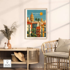 Valencia Poster Spain - Sunny Street Scene - Mediterranean City Wall Art displayed in a stylish interior with rattan furniture.
