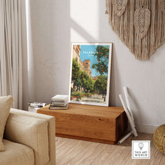 Valencia Spain Orange Tree Plaza Print - Historic City Street Poster displayed in a cozy room on a wooden table.