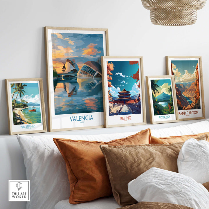 Valencia travel poster displayed with other scenic art prints in a cozy living room setting.