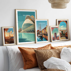 Valencia Travel Print Spain displayed among other travel prints on a stylish couch showcasing vibrant home decor.