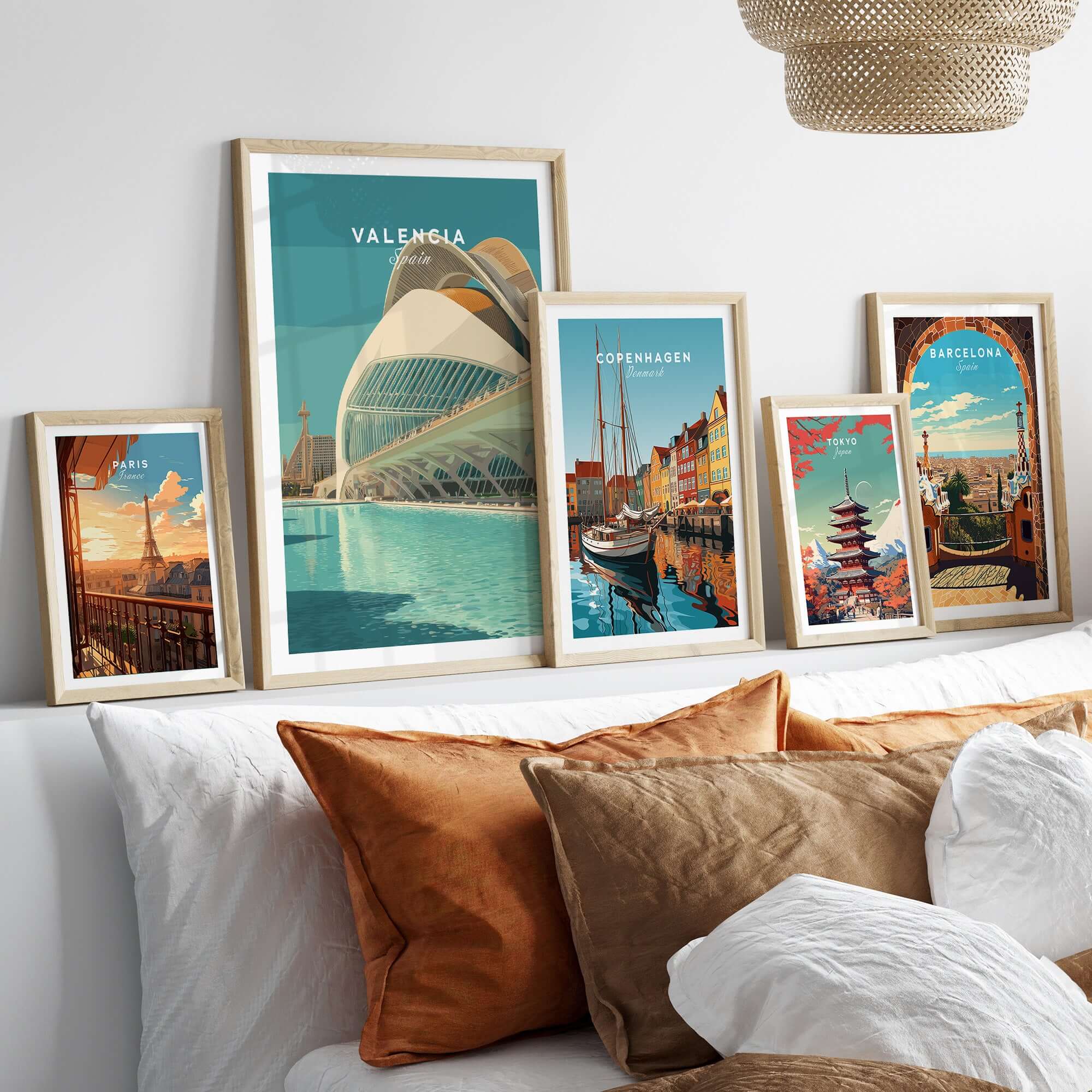 Valencia Travel Print Spain displayed among other travel prints on a stylish couch showcasing vibrant home decor.