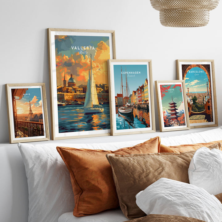 Assorted travel wall art prints including Valletta, Malta displayed above a cozy sofa