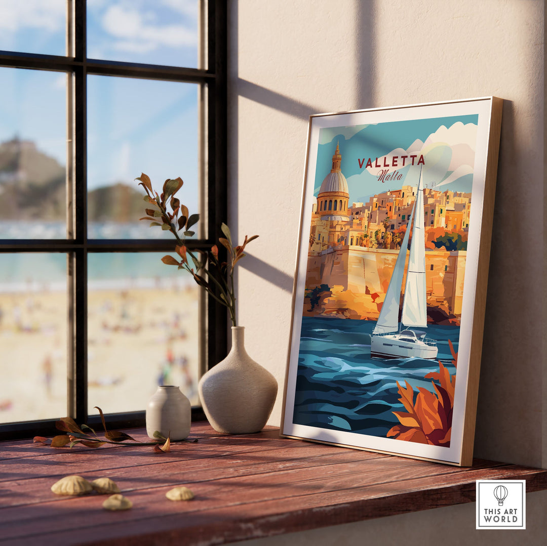 Valletta travel poster on a wooden shelf by a window, depicting a sailboat and historic buildings in Malta, vibrant wall art print.