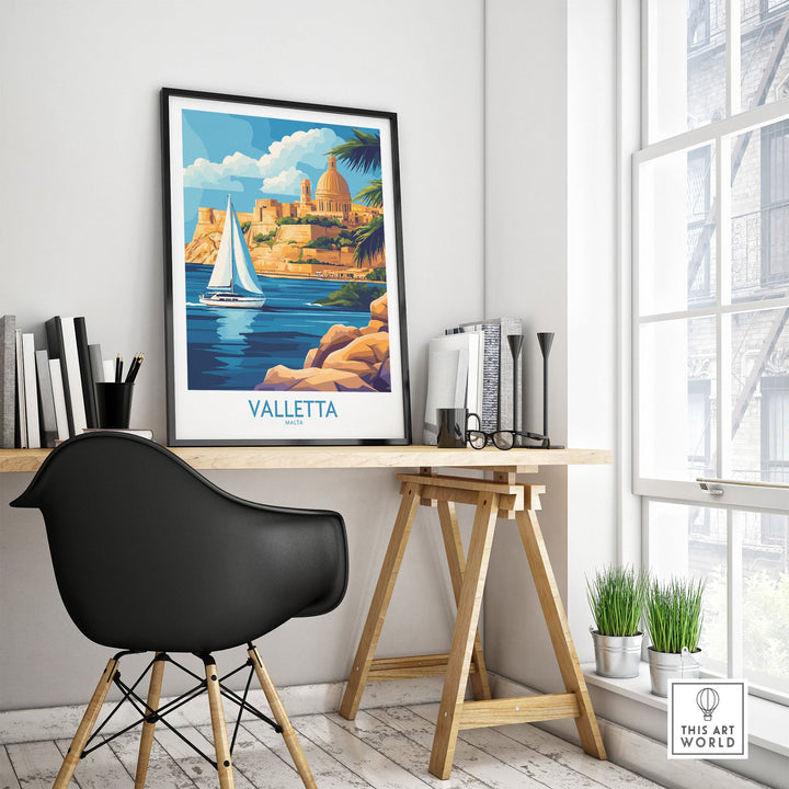 Valletta wall art poster on a wooden desk with a black chair beside a window, featuring a scenic view of Valletta, Malta.