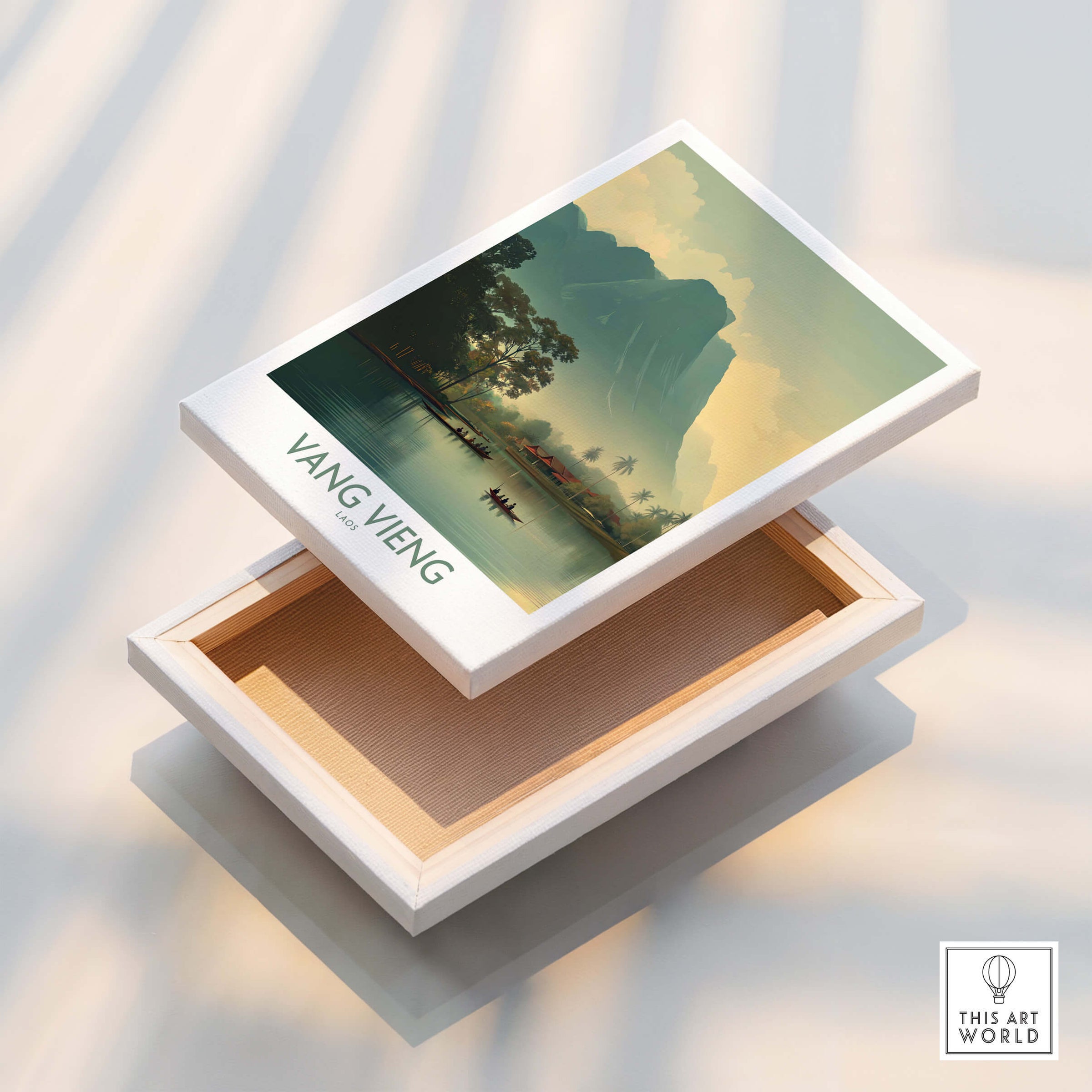Vang Vieng Canvas Print | Misty Mountain Laos Poster displayed on a box with layered mountains and calm waters.