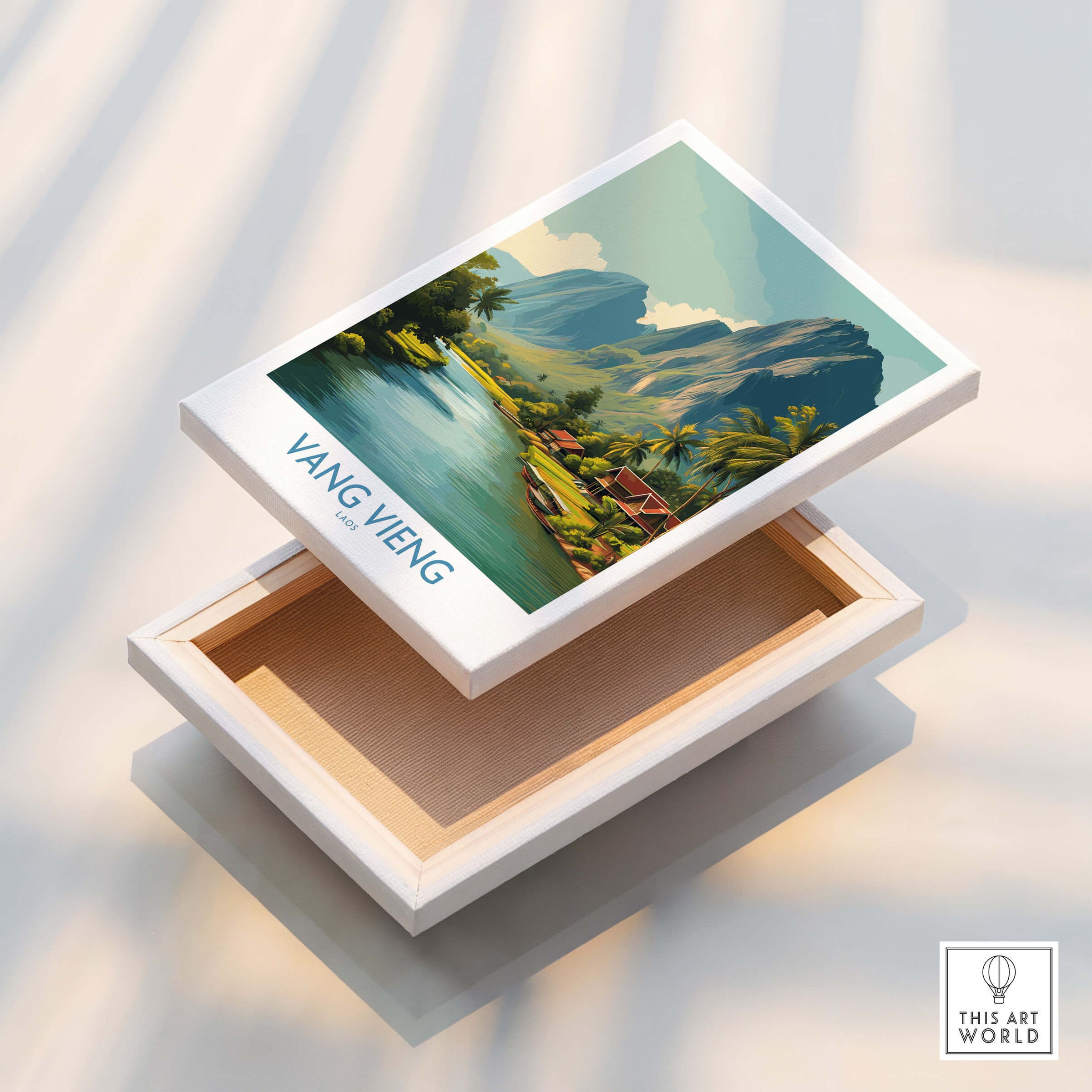 Vang Vieng Poster | Laos Village Canvas Print displayed on a white box with a serene riverside landscape.