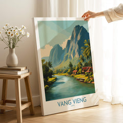 Vang Vieng Poster | Laos Village Canvas Print featuring a serene riverside scene with limestone cliffs and traditional homes.
