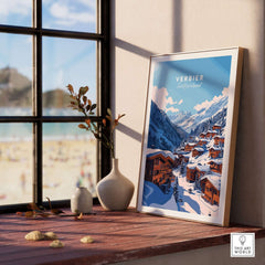 Verbier Travel Print displayed on a windowsill, showcasing a scenic winter landscape of Verbier, Switzerland. Perfect for ski enthusiasts.