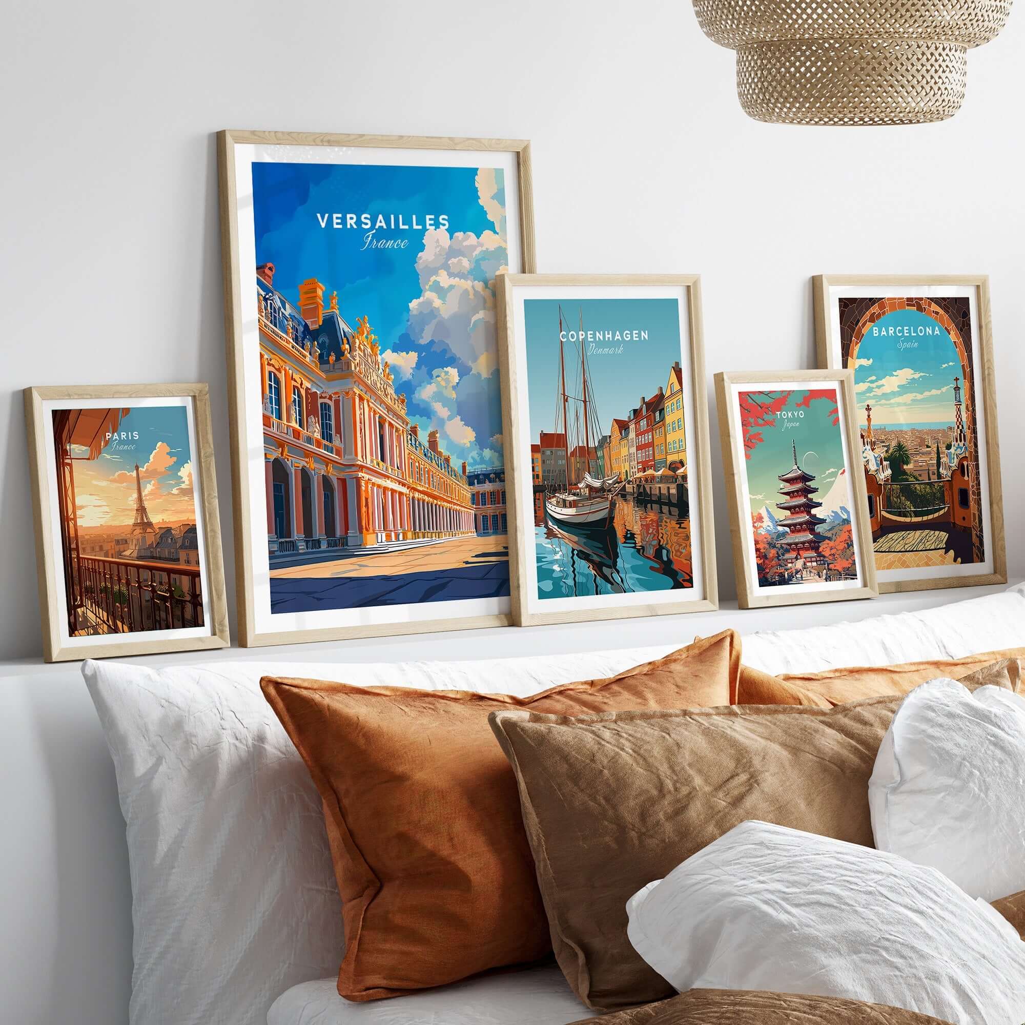 A stylish display of framed art prints, including Versailles Print France, on a modern wall above a cozy bed.