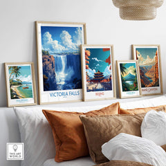Victoria Falls Poster displayed among other travel posters on a modern shelf in a stylish living room.