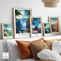 Victoria Falls Travel Poster displayed among other travel posters on a stylish shelf, enhancing home decor.
