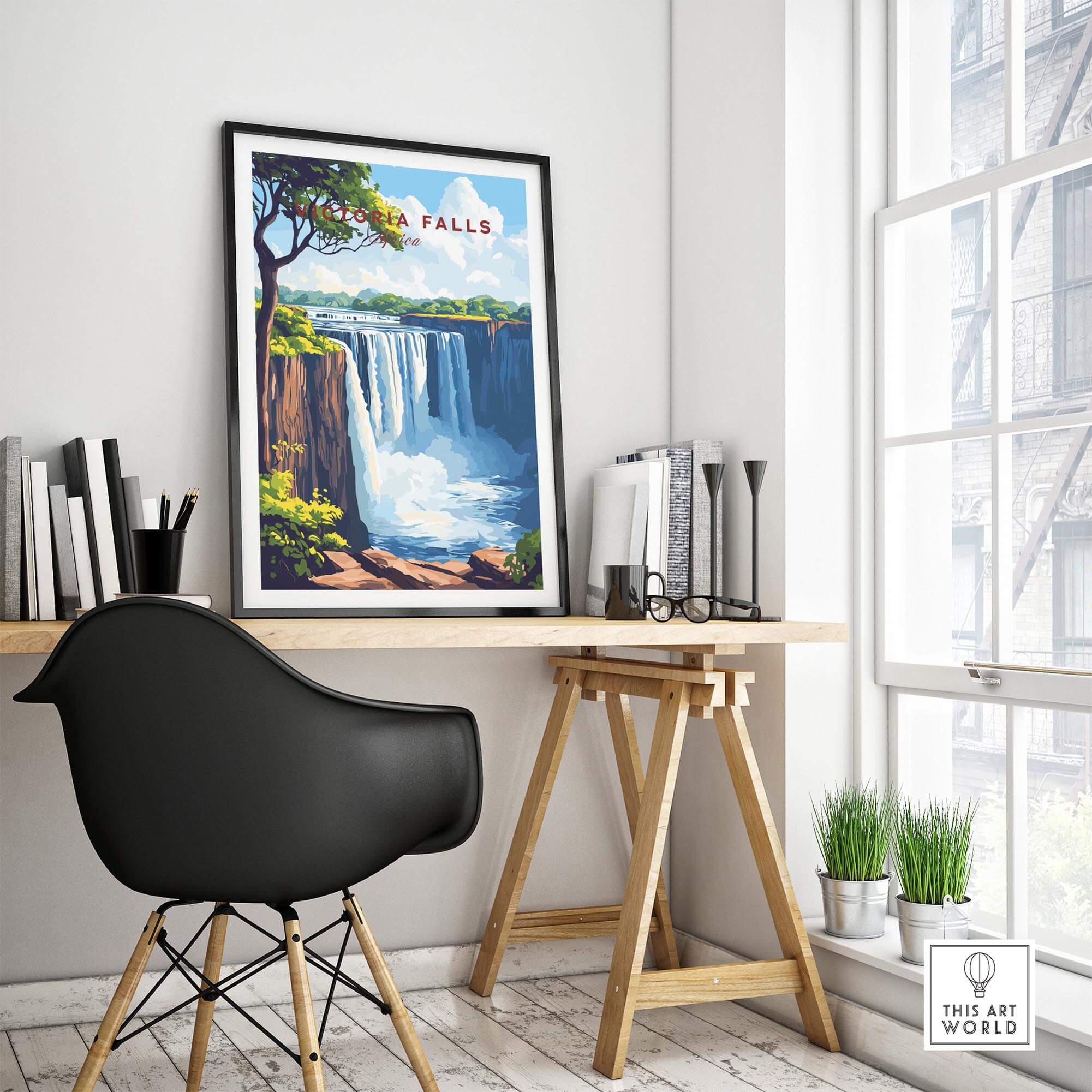 A stylish workspace featuring Victoria Falls Wall Art in a framed print, showcasing the majestic waterfalls in vibrant colors.