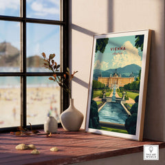 Vienna Travel Print framed on a wooden table with a scenic beach view outside the window.