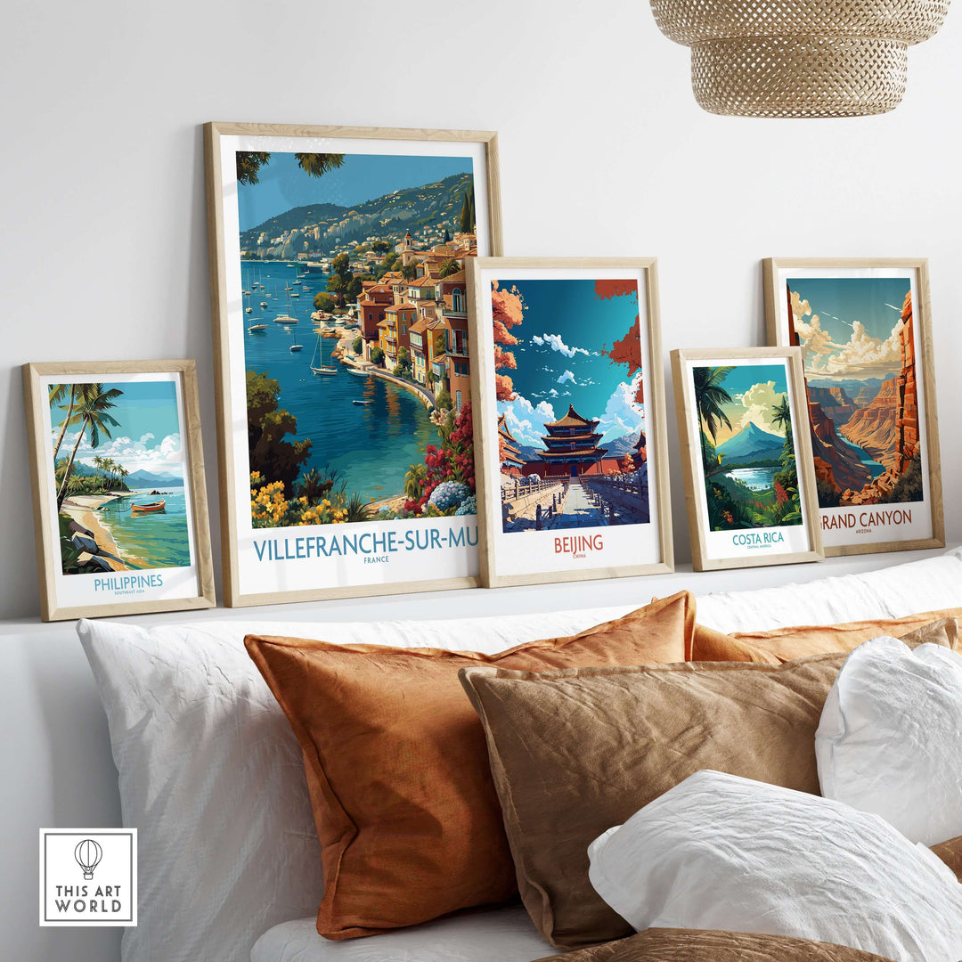 Stylish living room with framed Villefranche-sur-Mer print and other travel posters showcasing vibrant destinations.