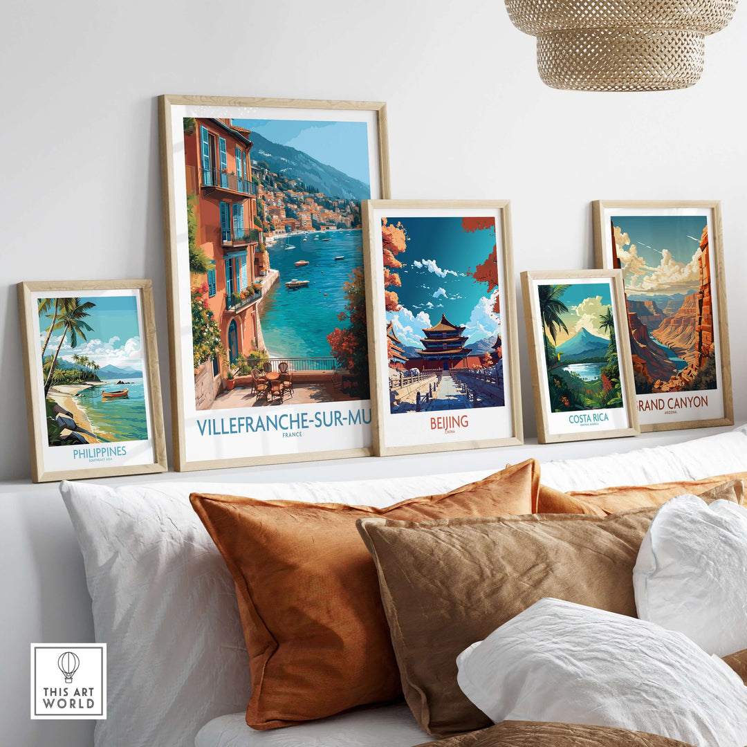 Framed Villefranche-sur-Mer poster with vibrant coastal views and other travel art prints on a stylish wall.