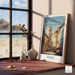 Vilnius Poster - Lithuania Old Town Wall Art - European City Print displayed on a windowsill with a scenic view.