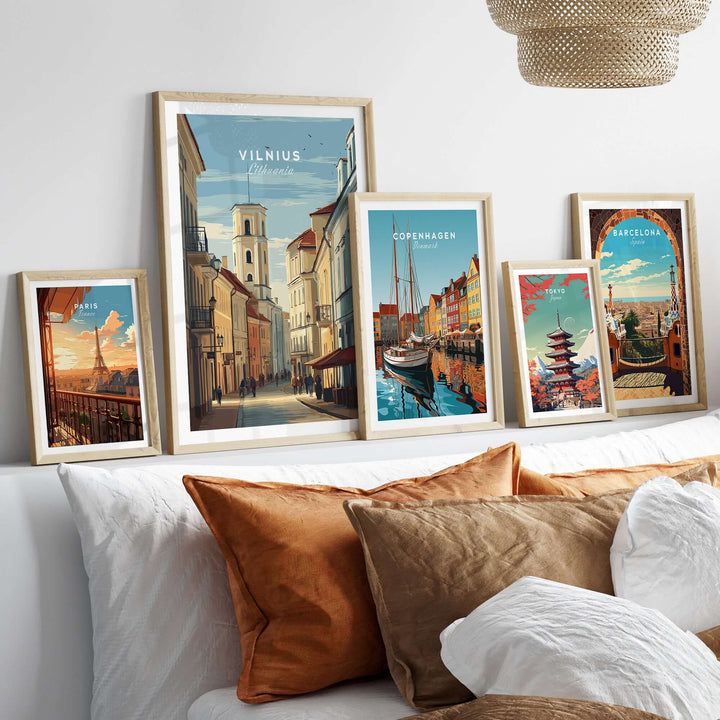 Framed travel posters of Vilnius, Copenhagen, and Barcelona displayed on a modern bedroom wall.