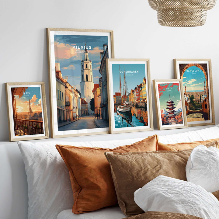 Vilnius poster and other city prints displayed on a cozy sofa, showcasing vibrant urban artwork and decor.