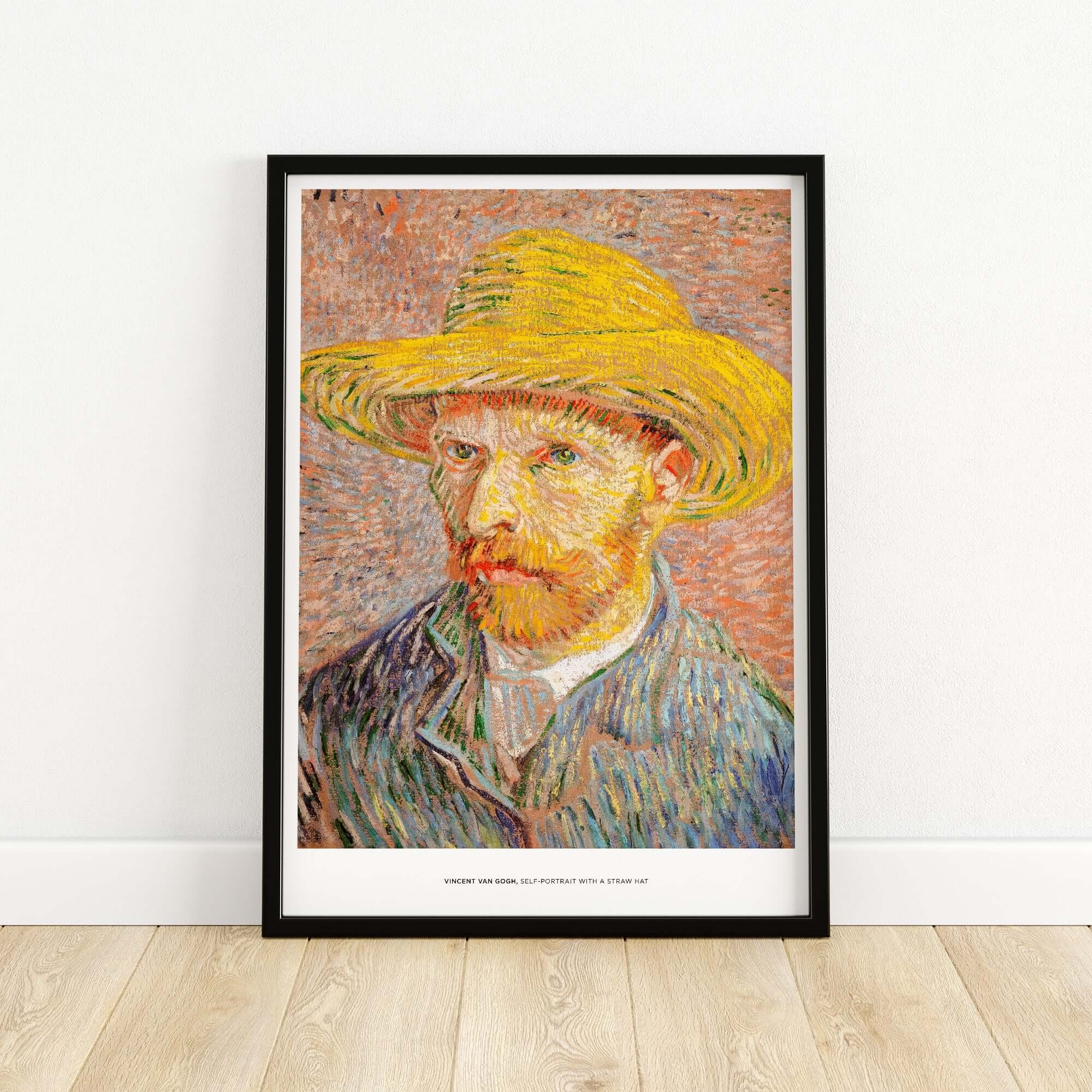 Vincent van Gogh Self Portrait Straw Hat Post-Impressionist Art Print Poster displayed in a black frame on wooden floor.
