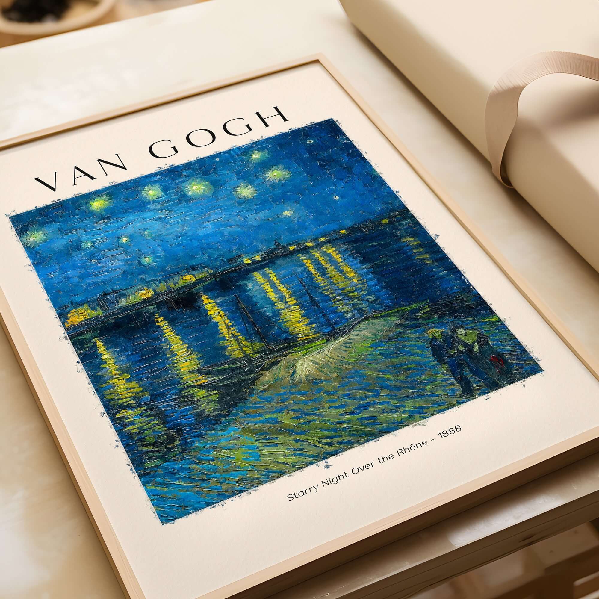 Vincent van Gogh Starry Night Over the Rhône 1888 Post Impressionist Landscape Poster Print framed on a table.